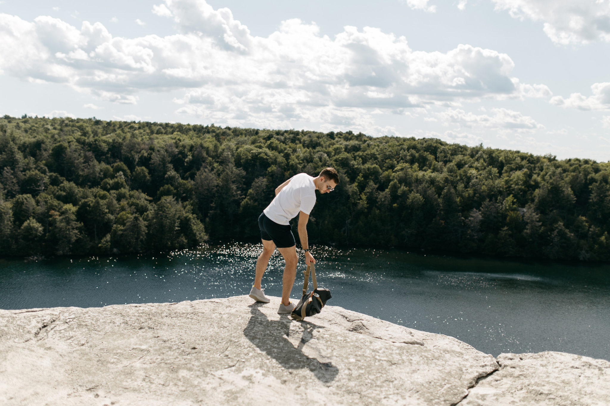 man in short shorts stands on a cliff