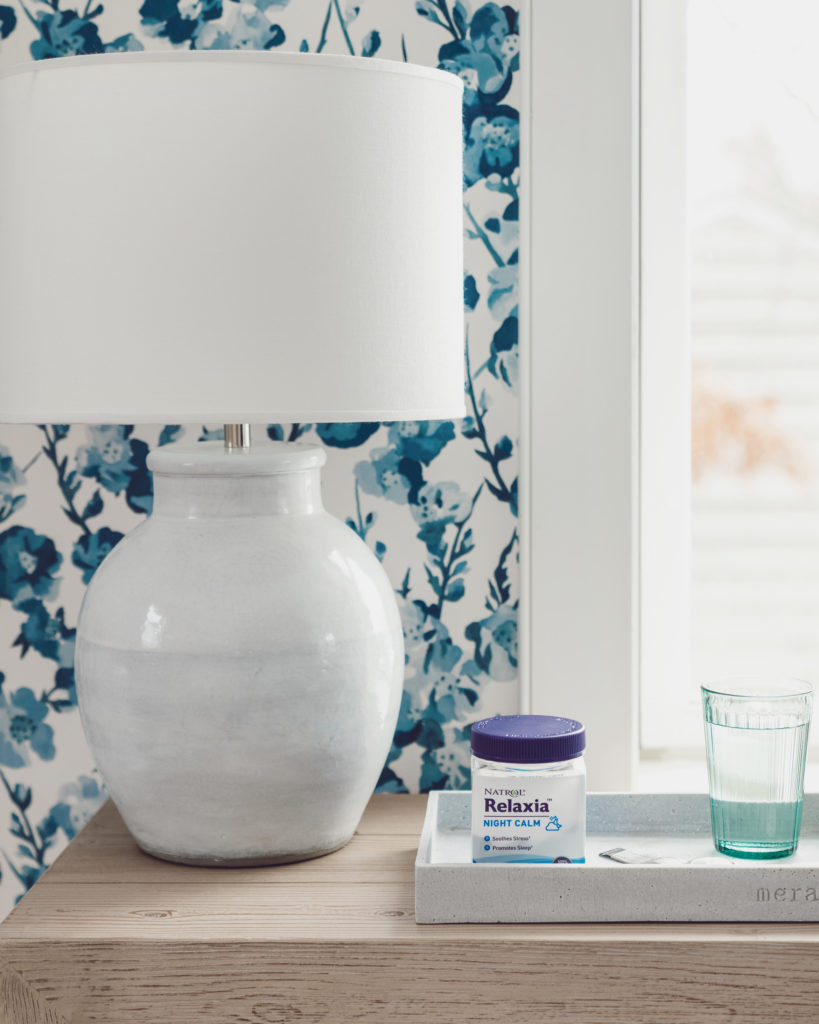 nightstand with blue floral wallpaper