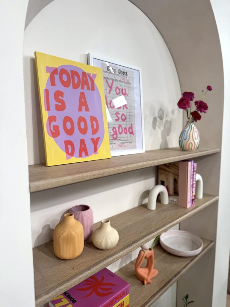 Open shelves with art colorful bold canvas pink yellow